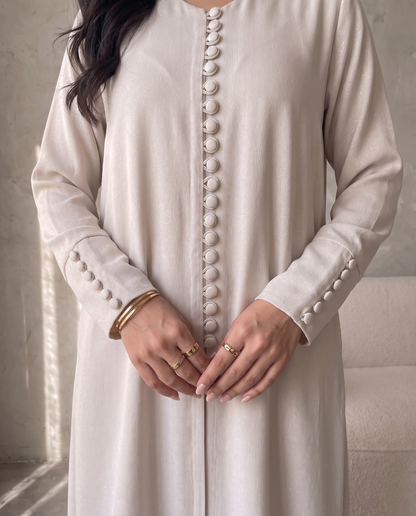 Pearl Button-Front Beige Abaya with Elegant Panel Design